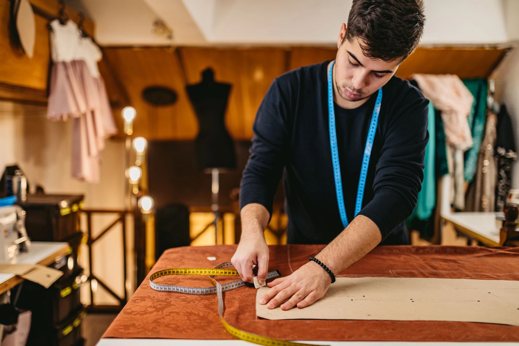 Fashion designer working in an atelier with patterns
