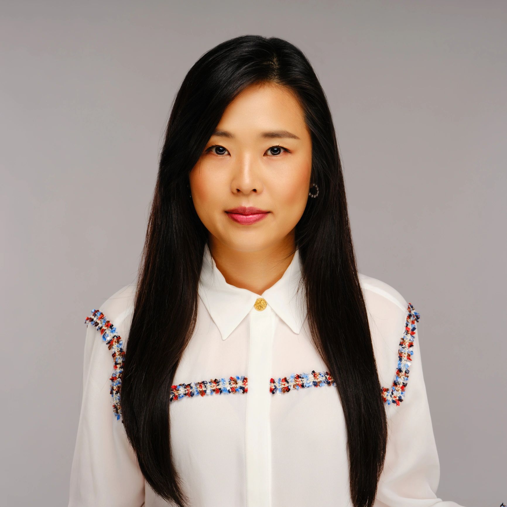 Studio headshot of a woman on a neutral background