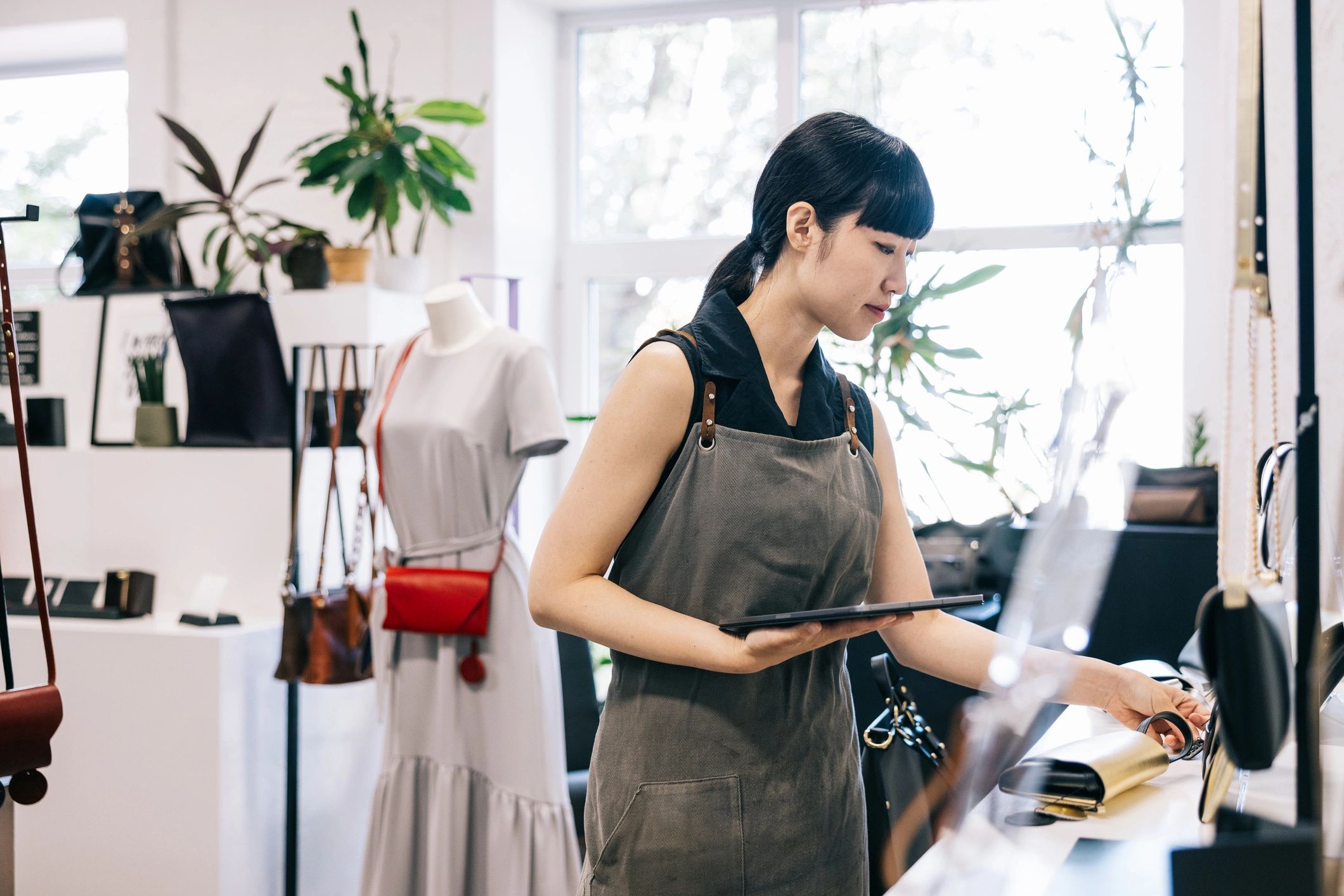 Small business owner using a tablet at the counter