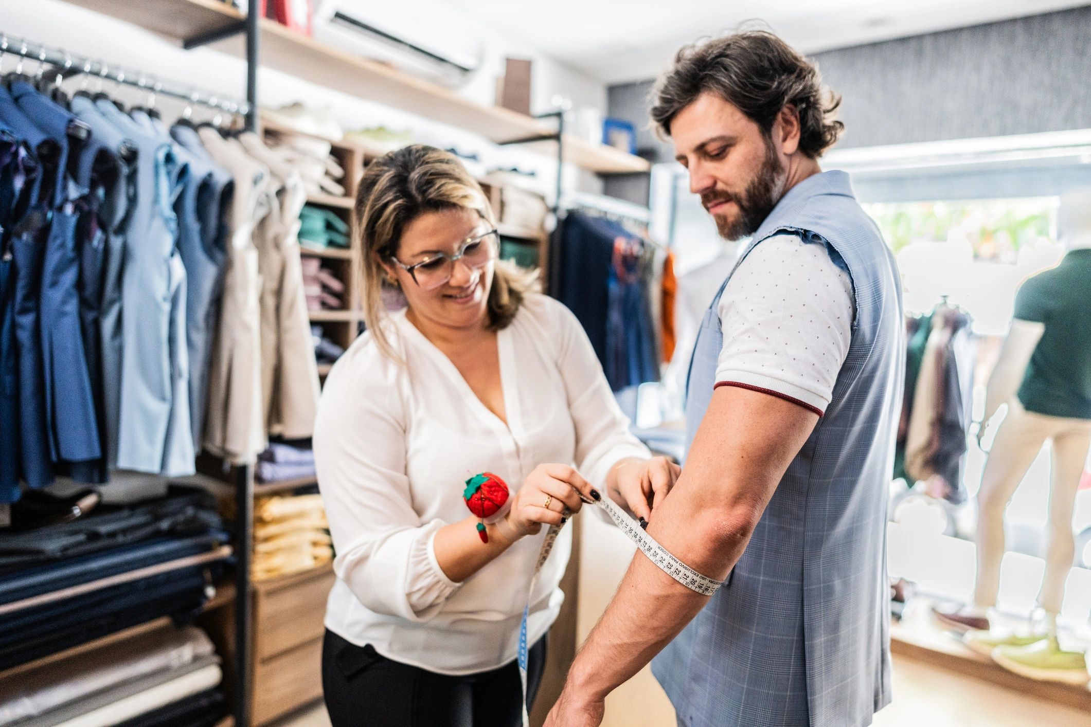Tailor measuring a customer for a suit, representing real shop workflows