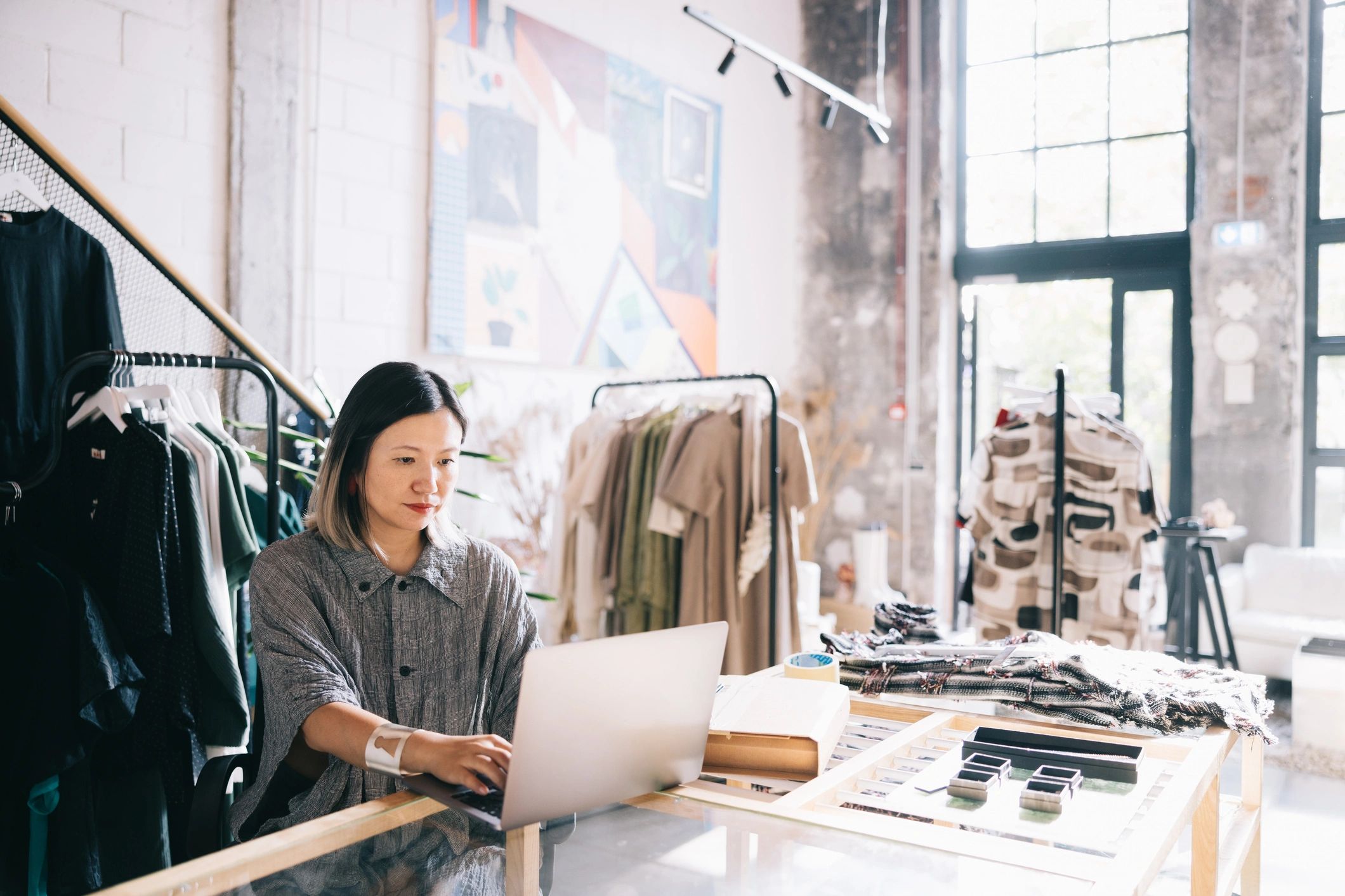 Shop owner using a laptop to manage orders